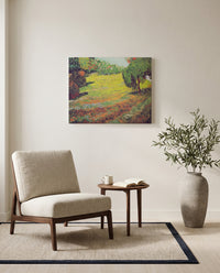 Sunny Lawn in a Public Park by Vincent van Gogh as a stretched canvas above a linen lounge chair in a reading corner