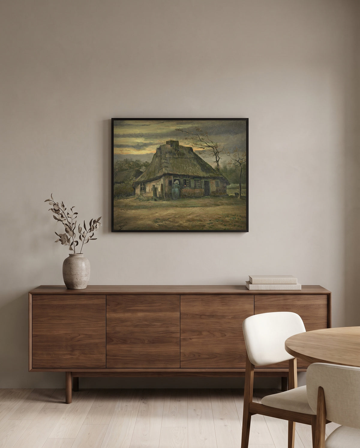 The Cottage by Vincent van Gogh in a black frame above a walnut sideboard in a dining room