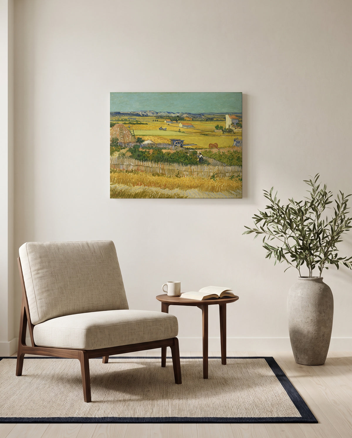 The Harvest by Vincent van Gogh as a stretched canvas above a linen lounge chair in a reading corner