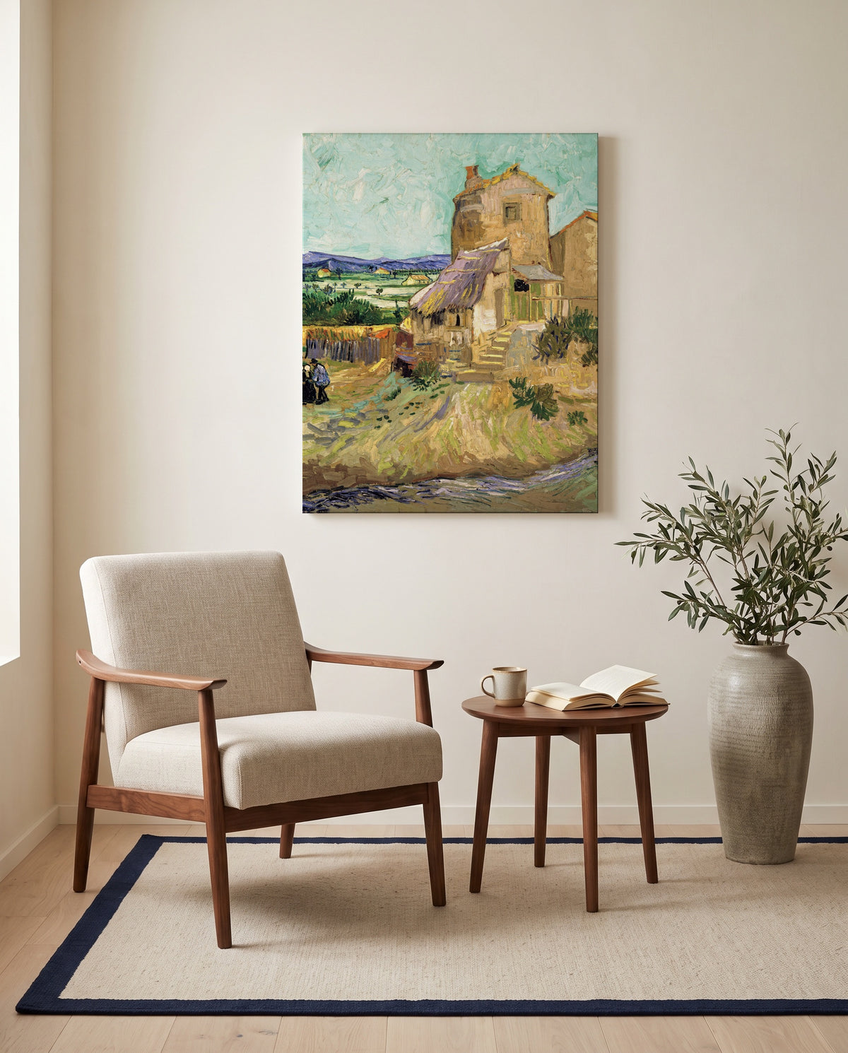 The Old Mill by Vincent van Gogh as a stretched canvas above a linen lounge chair in a reading corner