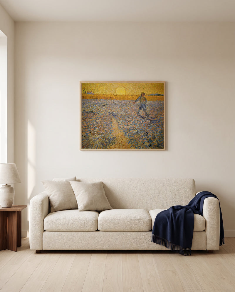 The Sower by Vincent van Gogh framed in natural oak above a cream sofa in a warm living room