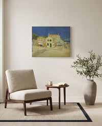 The Yellow House by Vincent van Gogh as a stretched canvas above a linen lounge chair in a reading corner