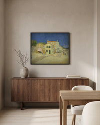 The Yellow House by Vincent van Gogh in a black frame above a walnut sideboard in a dining room