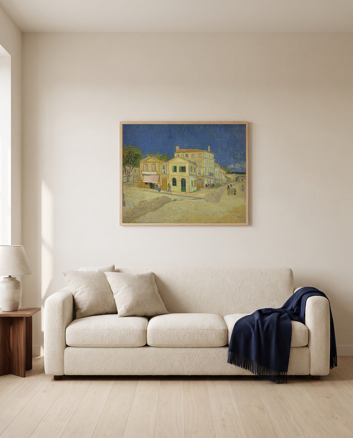 The Yellow House by Vincent van Gogh framed in natural oak above a cream sofa in a warm living room