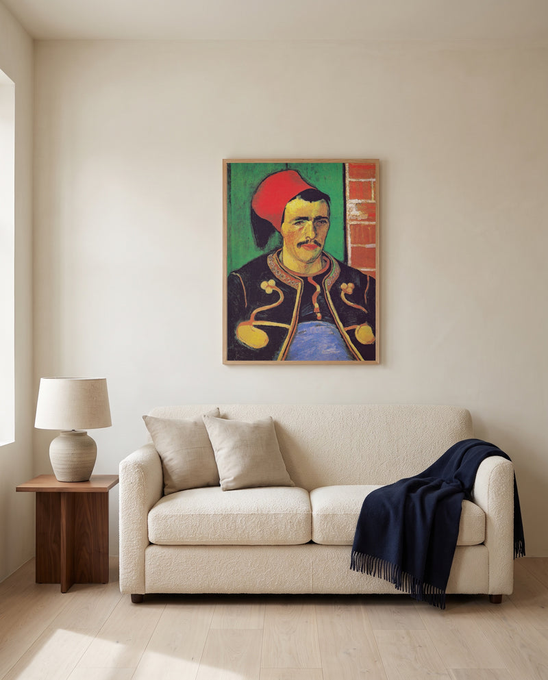 The Zouave by Vincent van Gogh framed in natural oak above a cream sofa in a warm living room