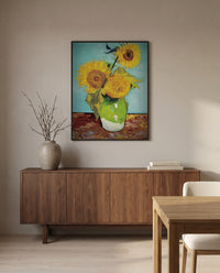 Three Sunflowers in a Vase by Vincent van Gogh in a black frame above a walnut sideboard in a dining room
