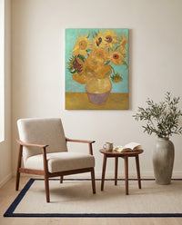 Twelve Sunflowers by Vincent van Gogh as a stretched canvas above a linen lounge chair in a reading corner
