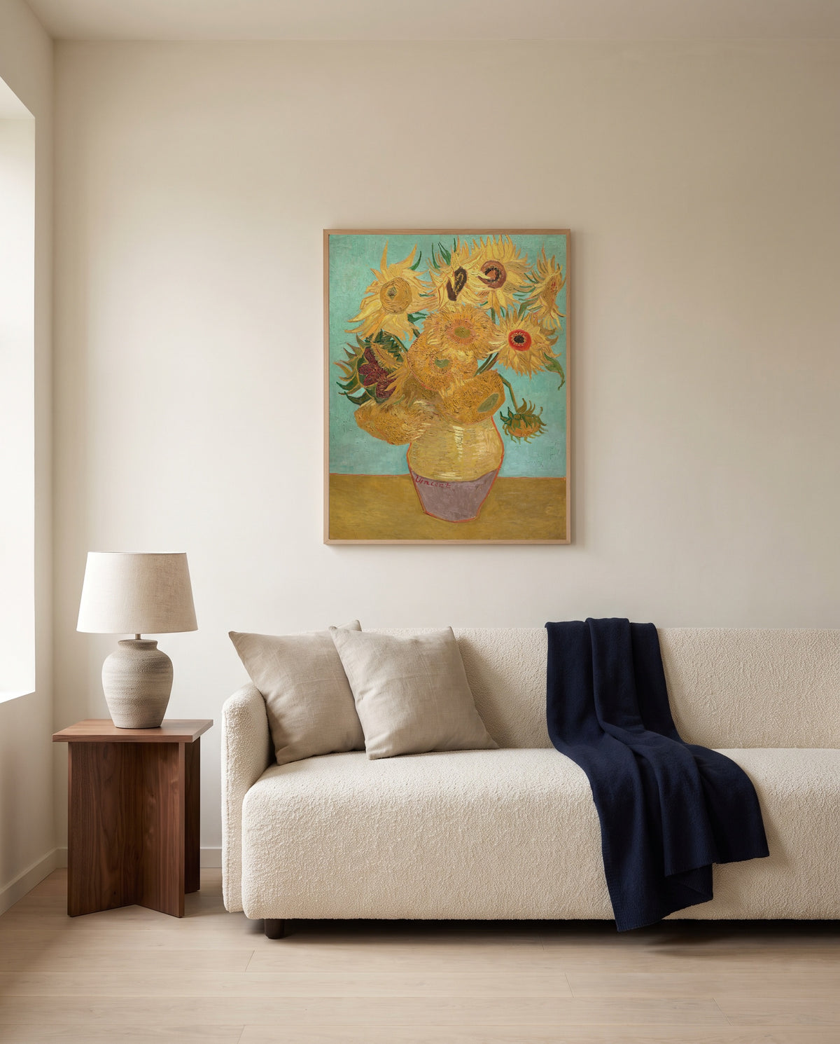 Twelve Sunflowers by Vincent van Gogh framed in natural oak above a cream sofa in a warm living room