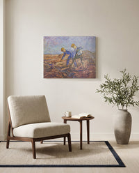Two Peasants Digging by Vincent van Gogh as a stretched canvas above a linen lounge chair in a reading corner