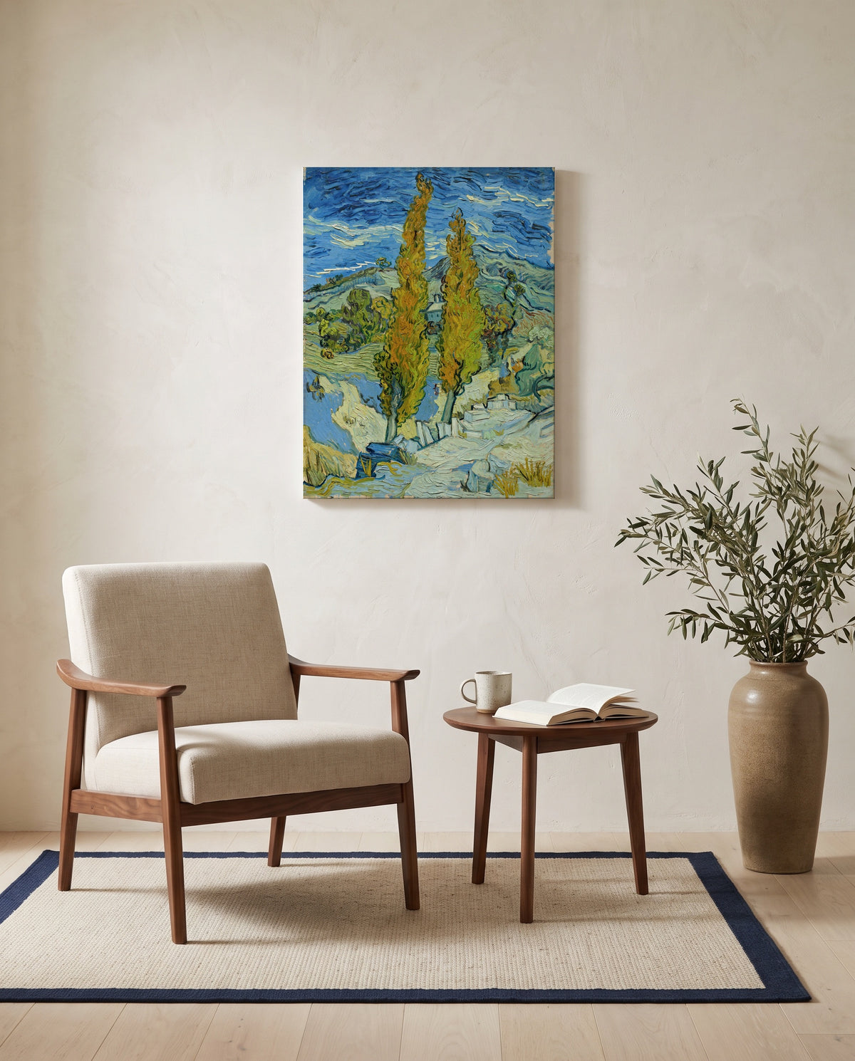 Two Poplars in the Alpilles by Vincent van Gogh as a stretched canvas above a linen lounge chair in a reading corner