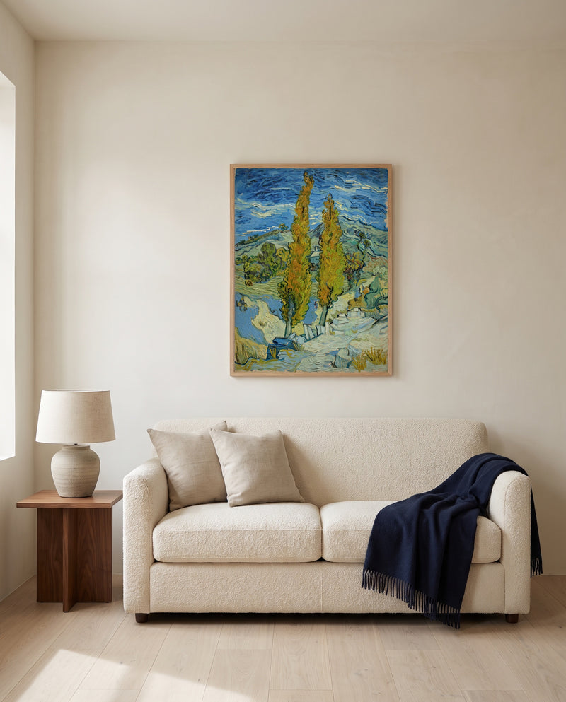 Two Poplars in the Alpilles by Vincent van Gogh framed in natural oak above a cream sofa in a warm living room