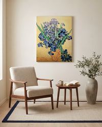 Vase with Irises by Vincent van Gogh as a stretched canvas above a linen lounge chair in a reading corner