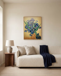 Vase with Irises by Vincent van Gogh framed in natural oak above a cream sofa in a warm living room