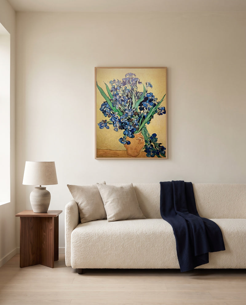 Vase with Irises by Vincent van Gogh framed in natural oak above a cream sofa in a warm living room