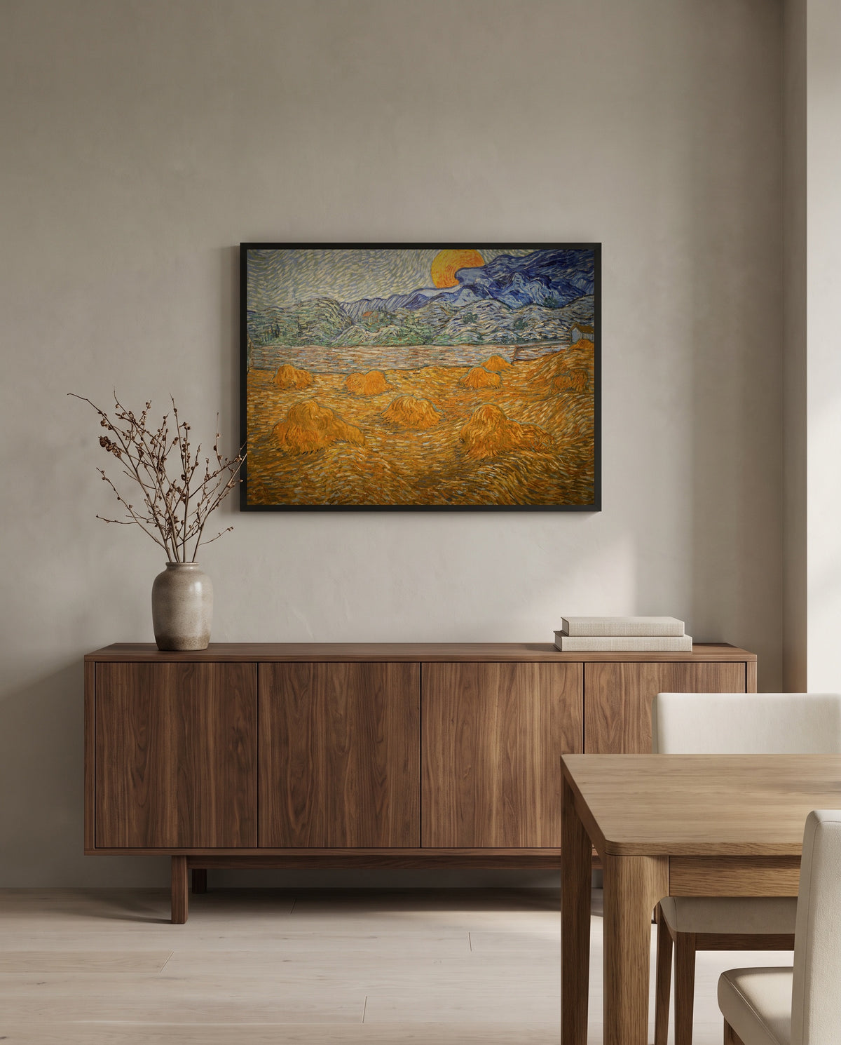 Wheat Sheaves and Rising Moon by Vincent van Gogh in a black frame above a walnut sideboard in a dining room