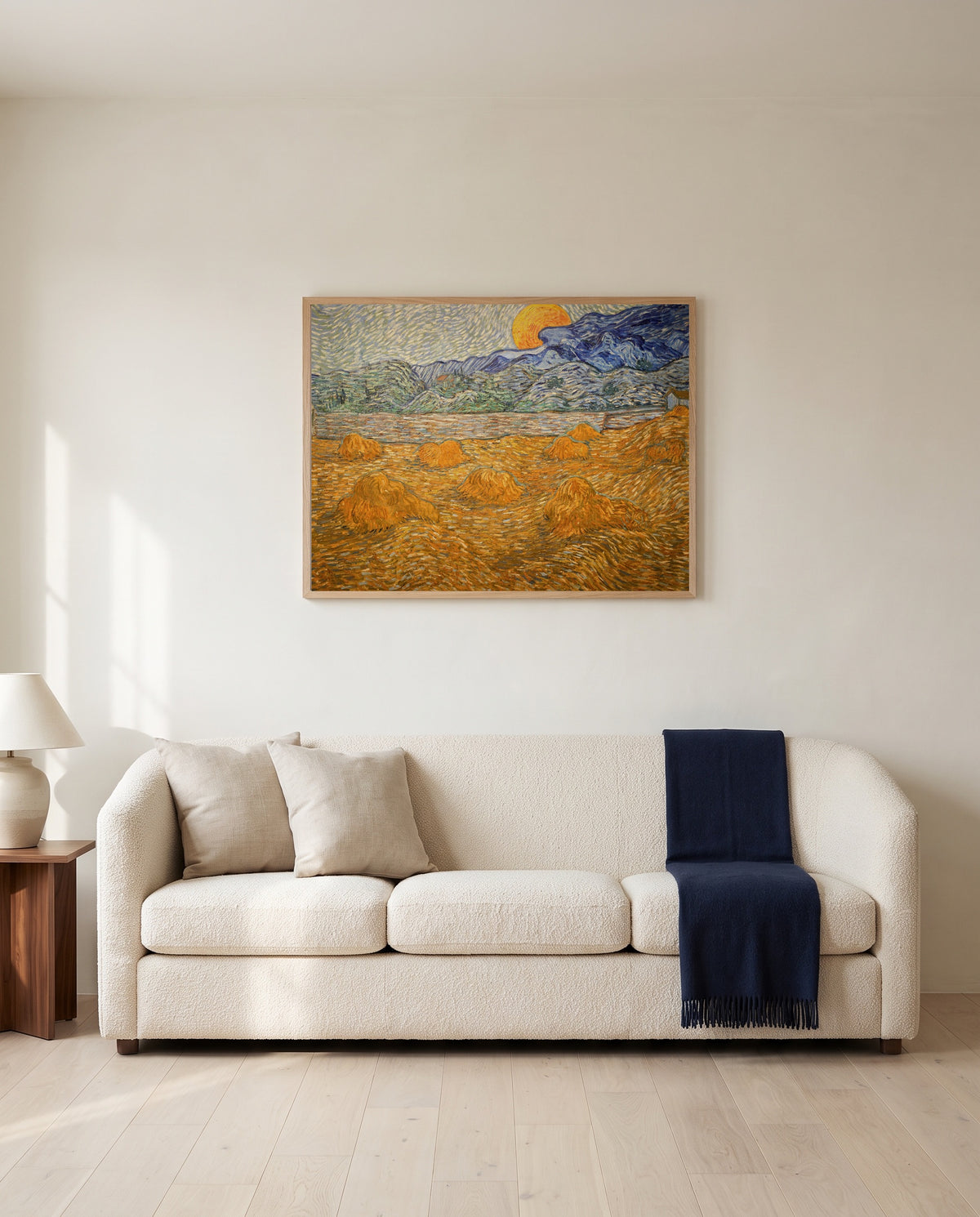 Wheat Sheaves and Rising Moon by Vincent van Gogh framed in natural oak above a cream sofa in a warm living room