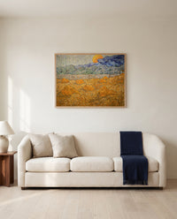 Wheat Sheaves and Rising Moon by Vincent van Gogh framed in natural oak above a cream sofa in a warm living room