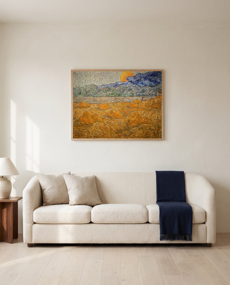 Wheat Sheaves and Rising Moon by Vincent van Gogh framed in natural oak above a cream sofa in a warm living room