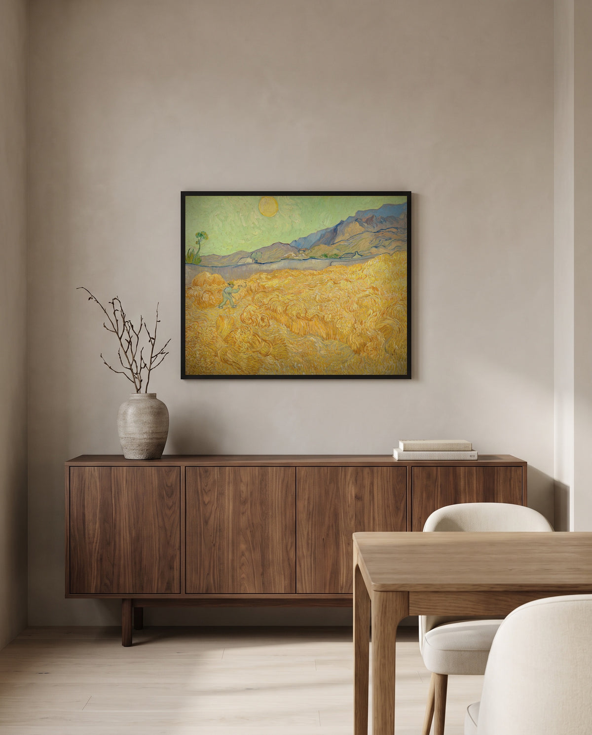 Wheatfield with a Reaper by Vincent van Gogh in a black frame above a walnut sideboard in a dining room