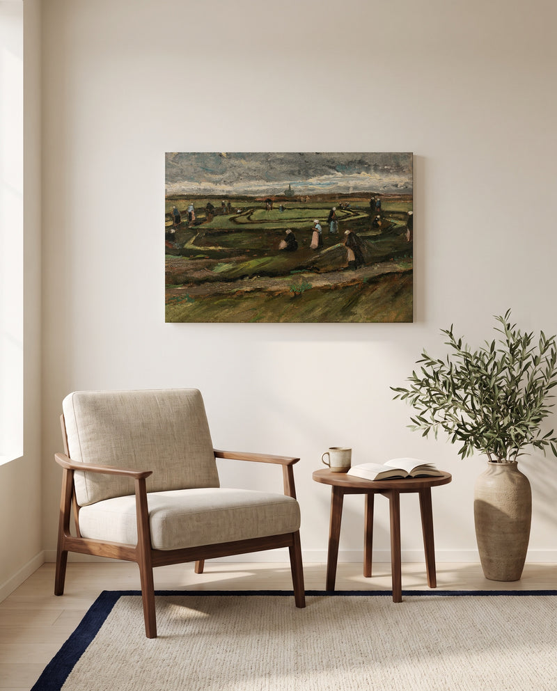 Women Mending Nets in the Dunes by Vincent van Gogh as a stretched canvas above a linen lounge chair in a reading corner