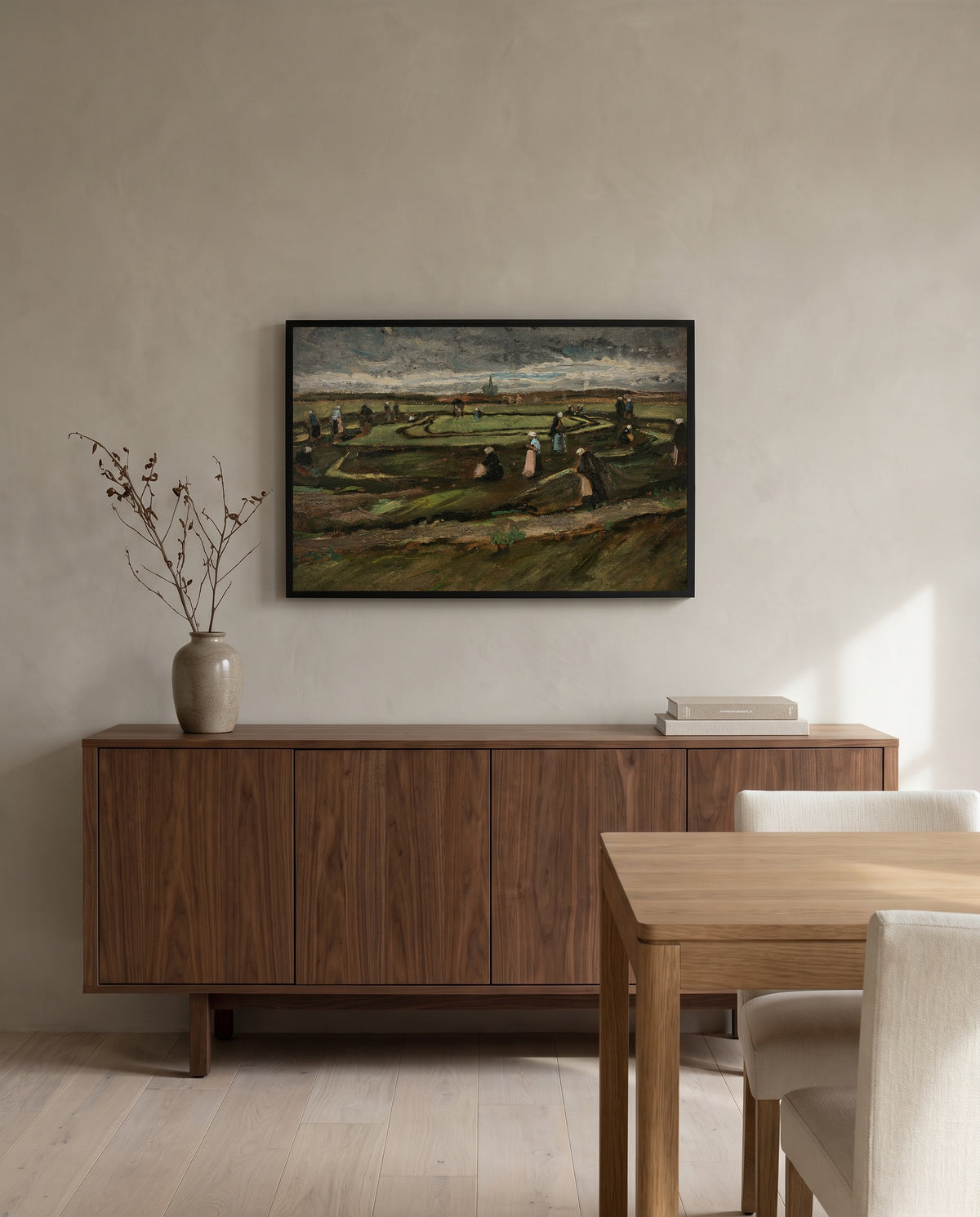Women Mending Nets in the Dunes by Vincent van Gogh in a black frame above a walnut sideboard in a dining room