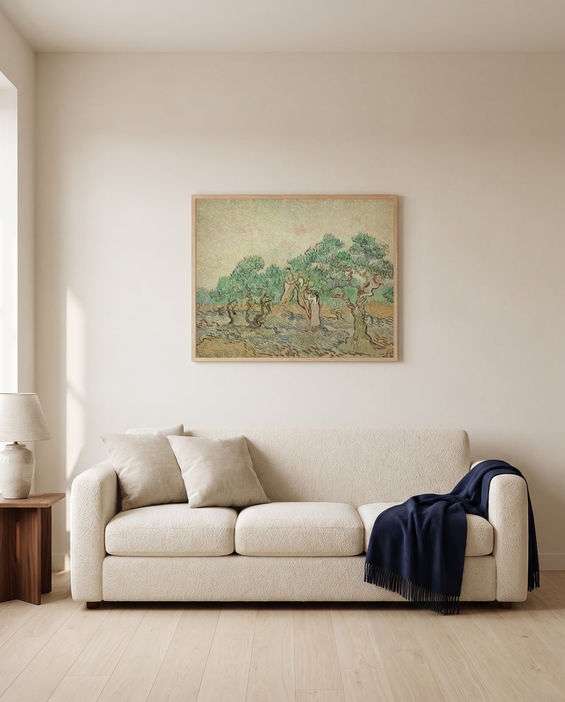 Women Picking Olives by Vincent van Gogh framed in natural oak above a cream sofa in a warm living room