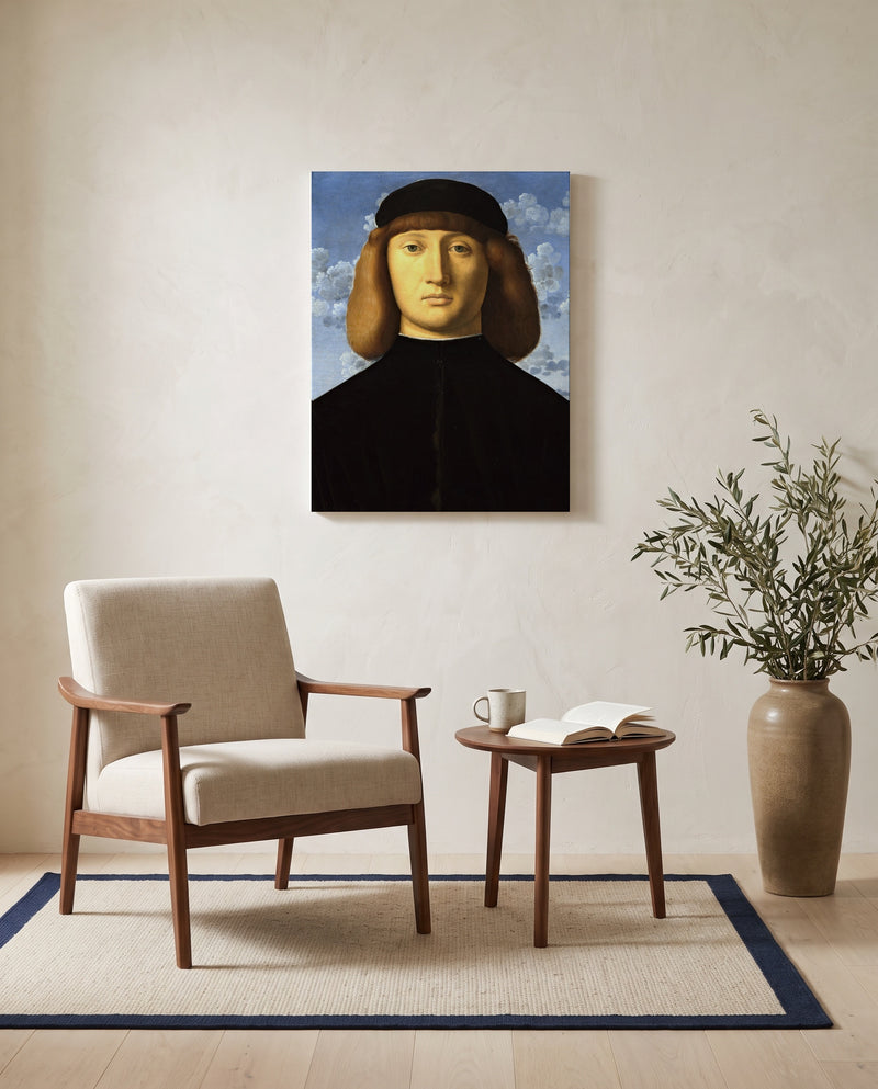 Portrait of a Young Man by Vincenzo Catena as a stretched canvas above a linen lounge chair in a reading corner