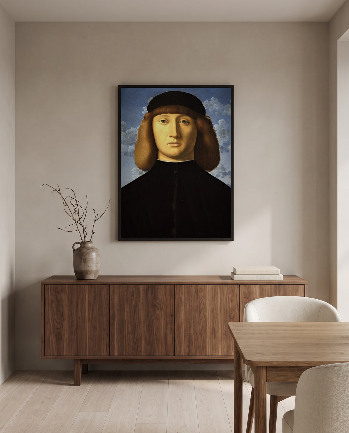 Portrait of a Young Man by Vincenzo Catena in a black frame above a walnut sideboard in a dining room