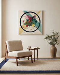 Circles in a Circle by Wassily Kandinsky as a stretched canvas above a linen lounge chair in a reading corner