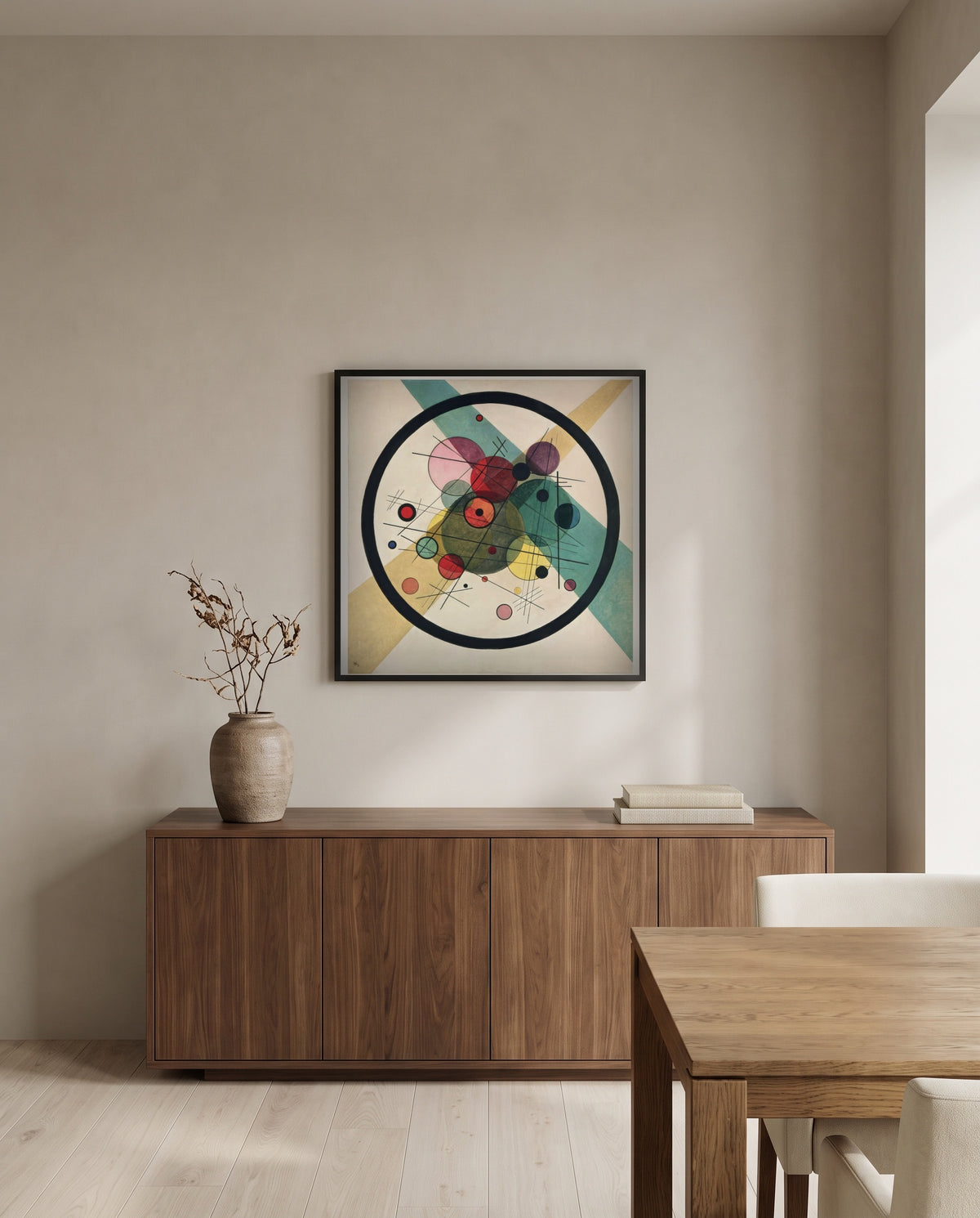 Circles in a Circle by Wassily Kandinsky in a black frame above a walnut sideboard in a dining room