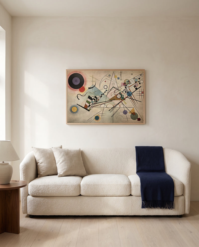 Composition VIII by Wassily Kandinsky framed in natural oak above a cream sofa in a warm living room
