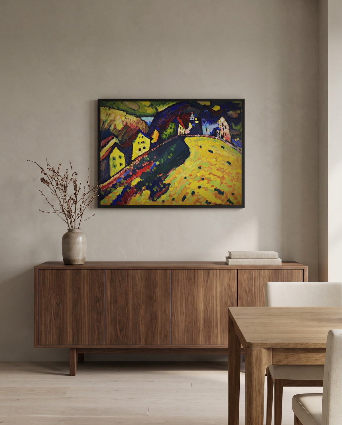 Houses at Murnau by Wassily Kandinsky in a black frame above a walnut sideboard in a dining room