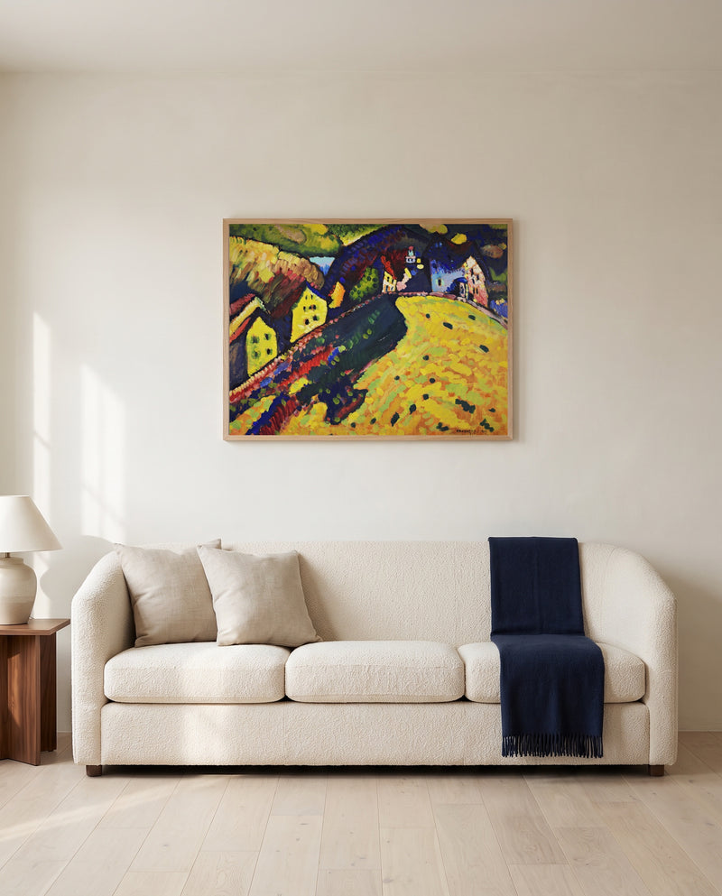 Houses at Murnau by Wassily Kandinsky framed in natural oak above a cream sofa in a warm living room