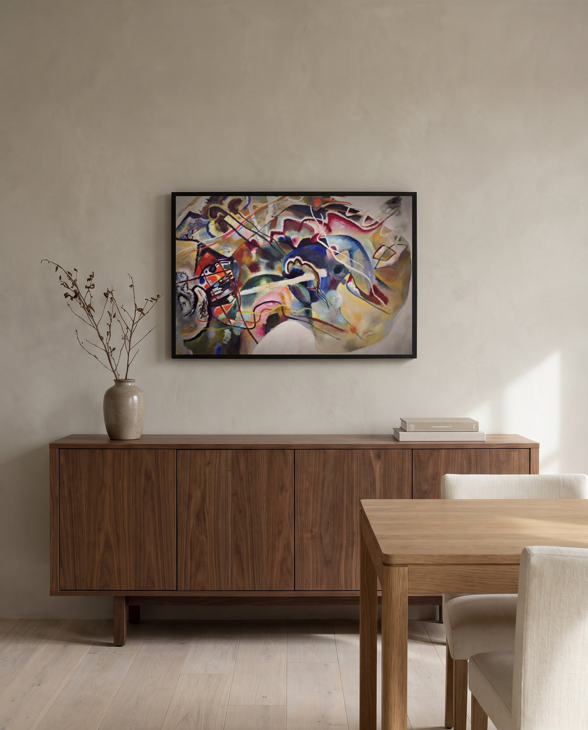 Painting with White Border by Wassily Kandinsky in a black frame above a walnut sideboard in a dining room