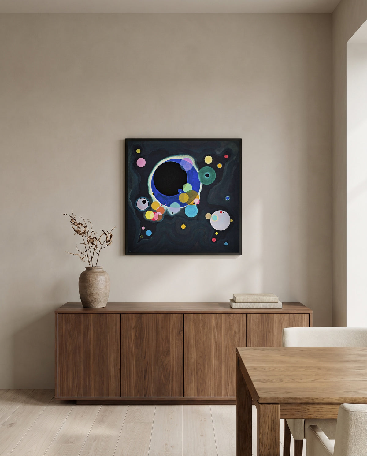 Several Circles by Wassily Kandinsky in a black frame above a walnut sideboard in a dining room