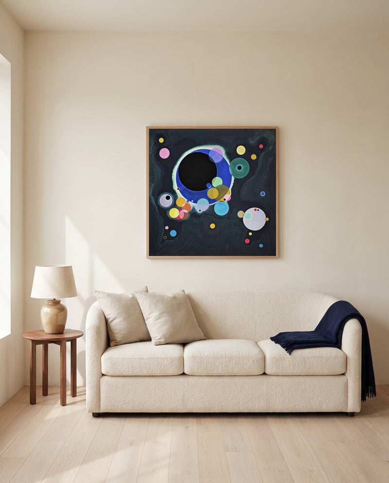 Several Circles by Wassily Kandinsky framed in natural oak above a cream sofa in a warm living room