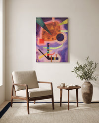 Three Elements by Wassily Kandinsky as a stretched canvas above a linen lounge chair in a reading corner