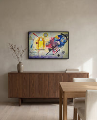 Yellow-Red-Blue by Wassily Kandinsky in a black frame above a walnut sideboard in a dining room