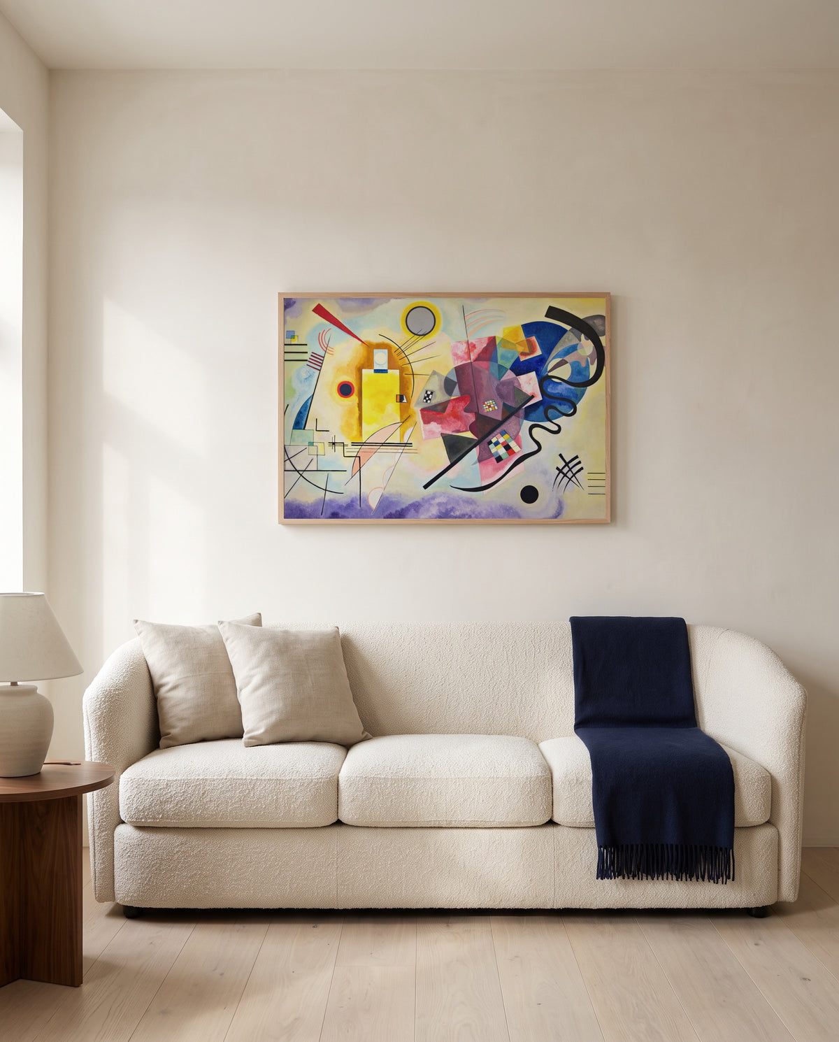 Yellow-Red-Blue by Wassily Kandinsky framed in natural oak above a cream sofa in a warm living room