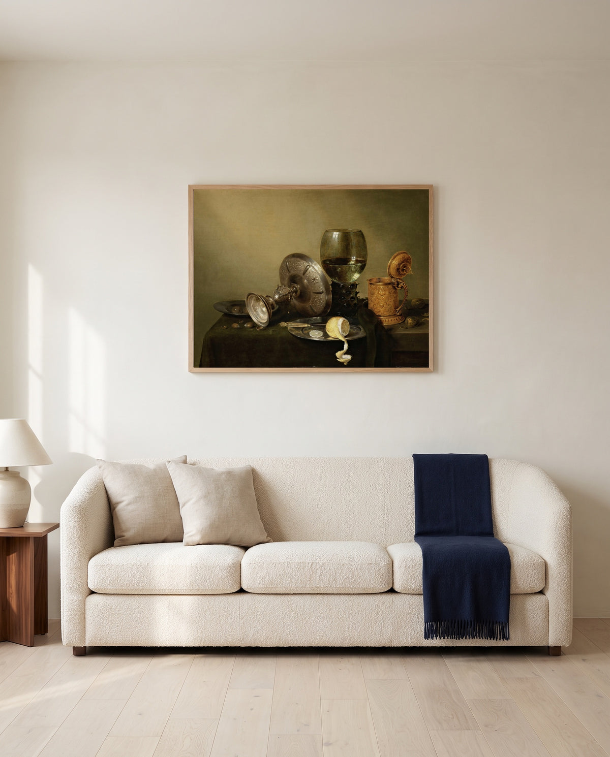 Gilded Beer Tankard by Willem Claesz. Heda framed in natural oak above a cream sofa in a warm living room