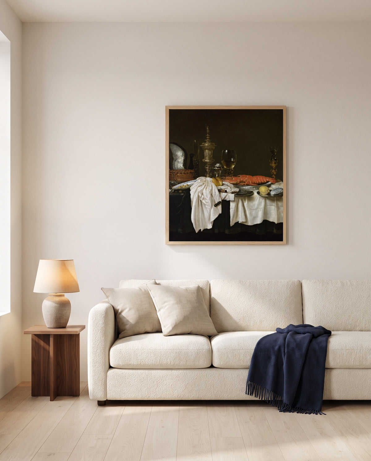 Still Life with a Lobster by Willem Claesz. Heda framed in natural oak above a cream sofa in a warm living room