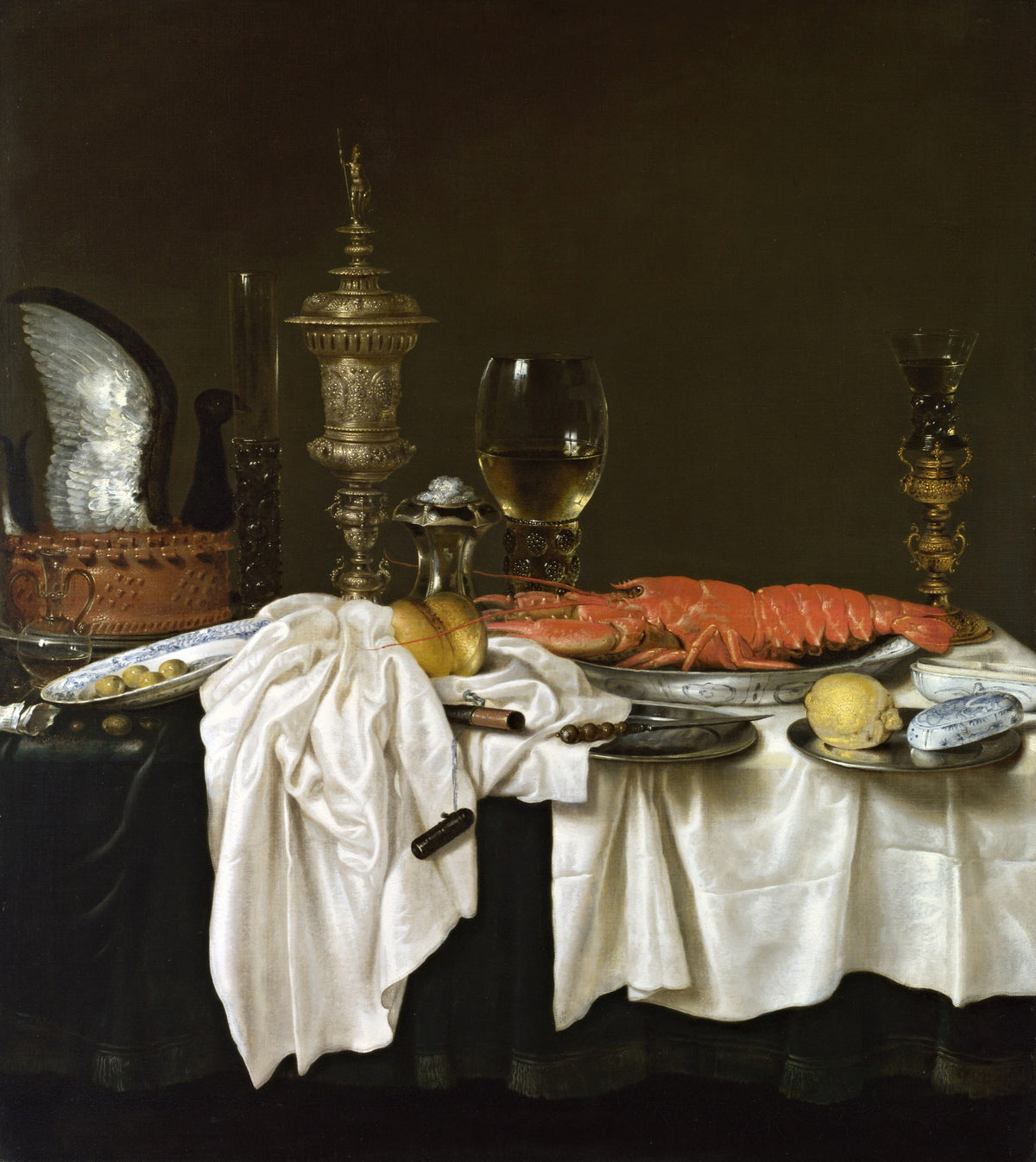 Still Life with a Lobster by Heda: a red lobster, a gold goblet, wine glasses and white satin cloths on a dark table