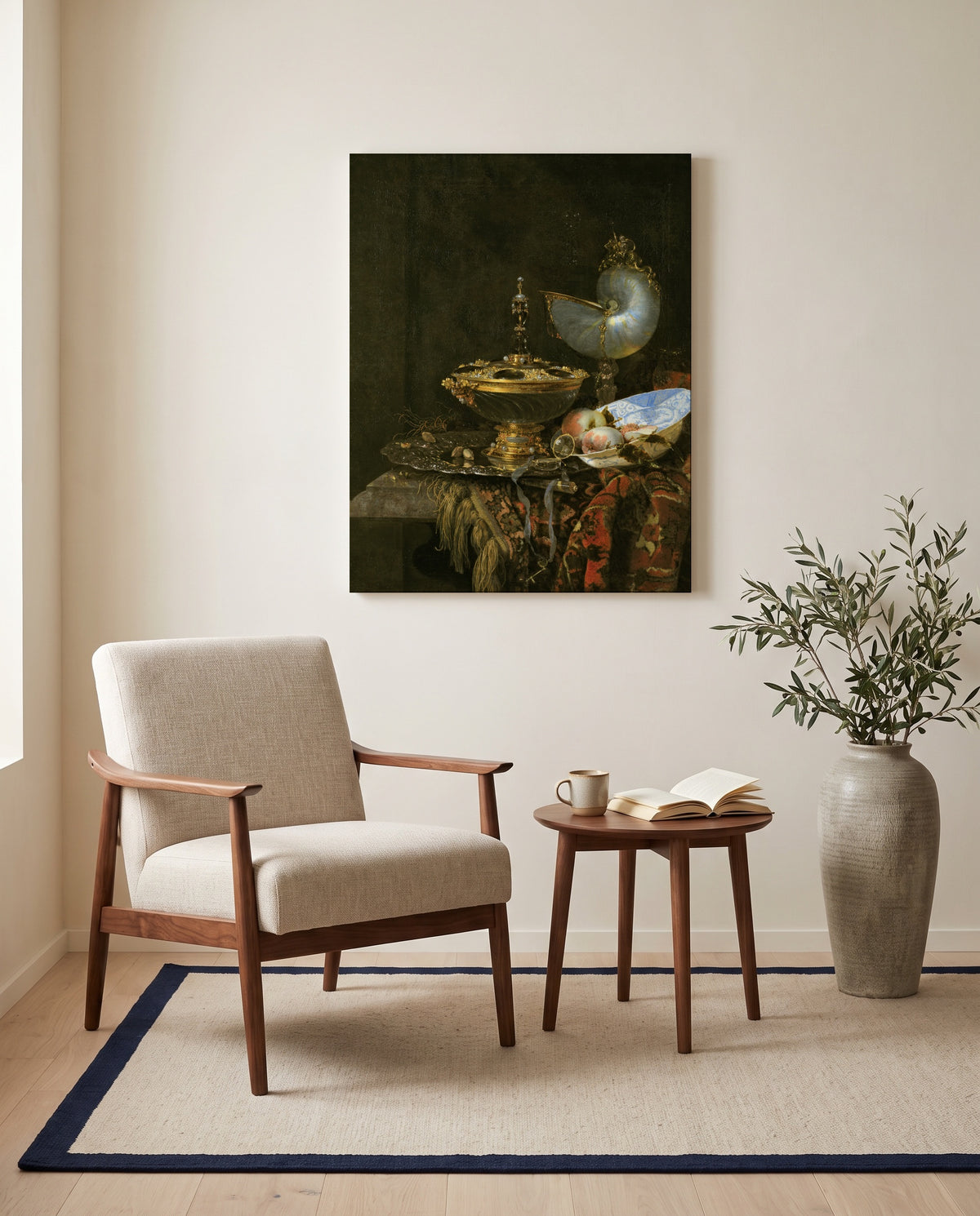 Holbein Bowl and Nautilus Cup by Willem Kalf as a stretched canvas above a linen lounge chair in a reading corner