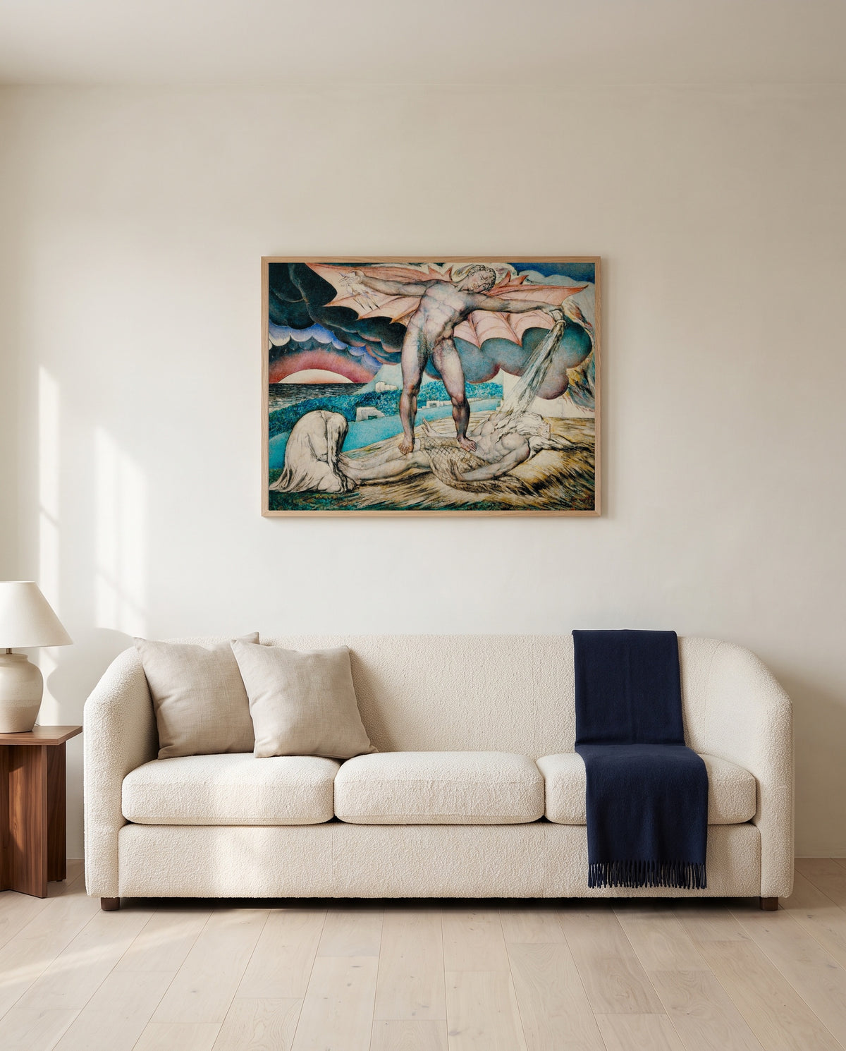 Satan Smiting Job by William Blake framed in natural oak above a cream sofa in a warm living room