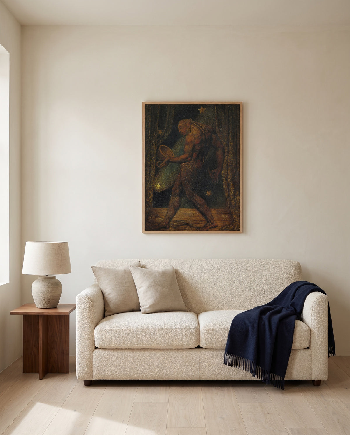 The Ghost of a Flea by William Blake framed in natural oak above a cream sofa in a warm living room