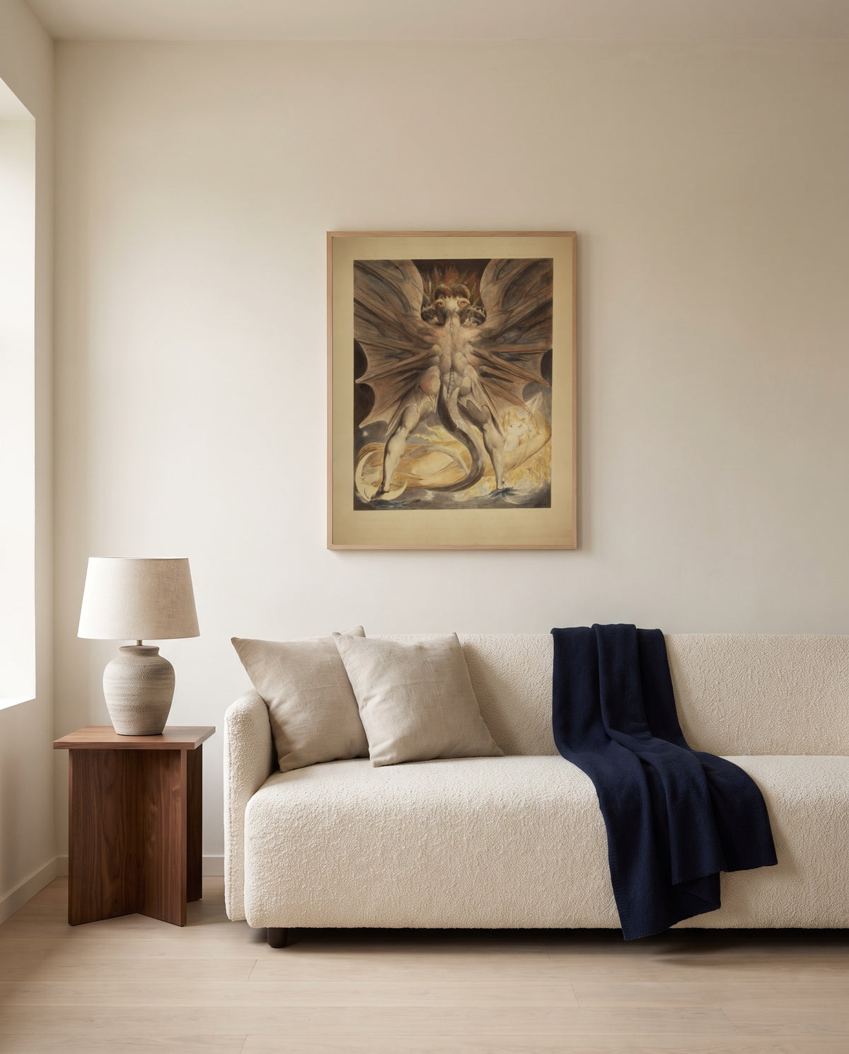 The Great Red Dragon by William Blake framed in natural oak above a cream sofa in a warm living room