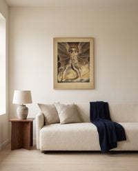 The Great Red Dragon by William Blake framed in natural oak above a cream sofa in a warm living room