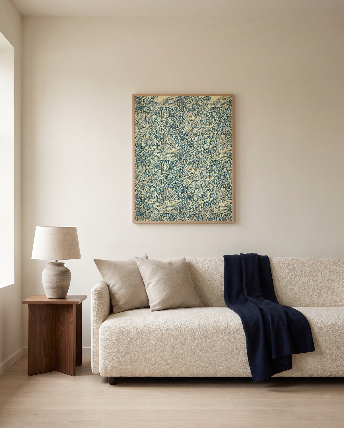 Marigold by William Morris framed in natural oak above a cream sofa in a warm living room