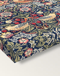 Strawberry Thief by William Morris on stretched canvas, corner close-up: the painting mirror-wrapped round the sides