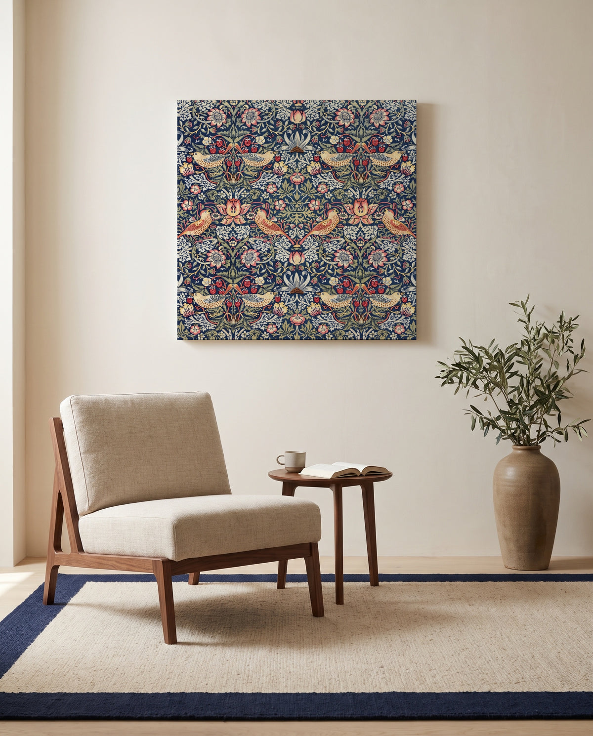 Strawberry Thief by William Morris as a stretched canvas above a linen lounge chair in a reading corner